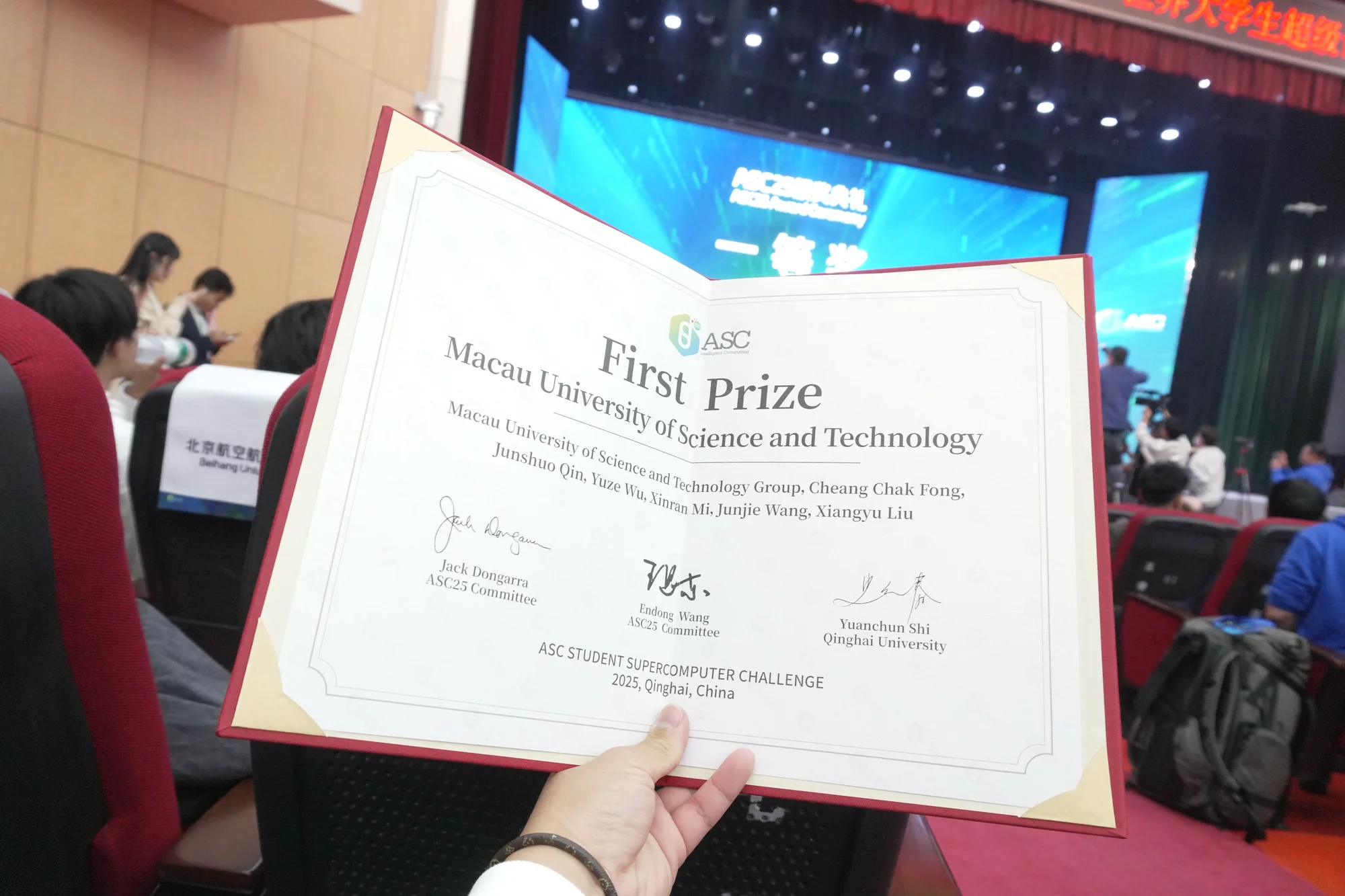 The First Prize certificate held open at the awards ceremony, awarded to Macau University of Science and Technology