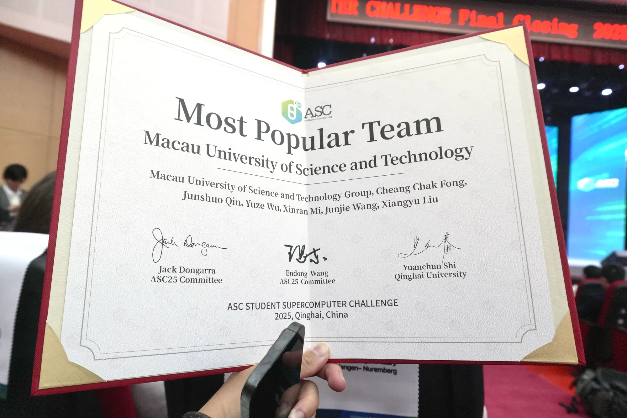 The Most Popular Team certificate held open, awarded to Macau University of Science and Technology