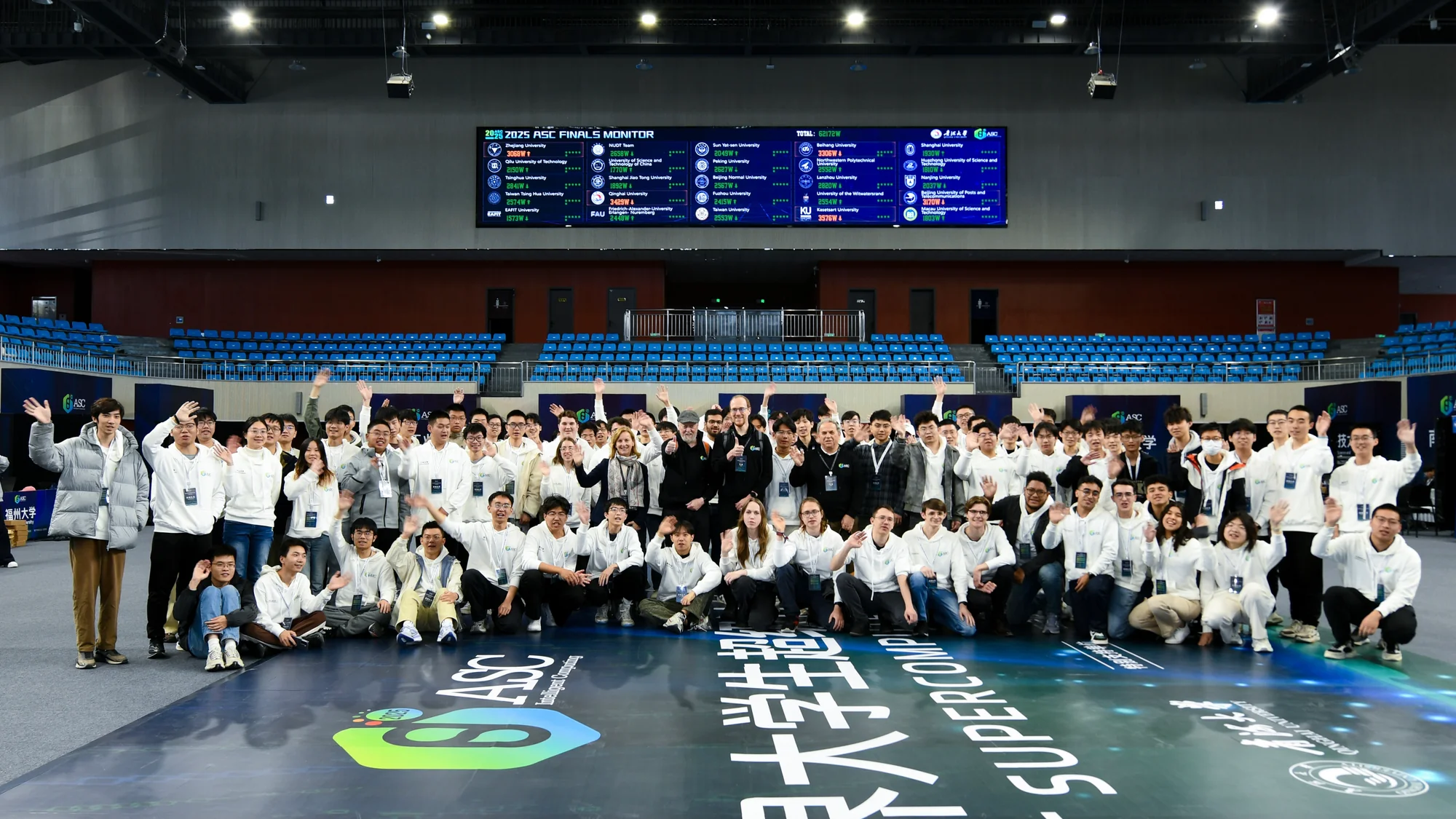 Competitors and judges, Jack Dongarra among them, waving around the ASC floor decal in the middle of the venue