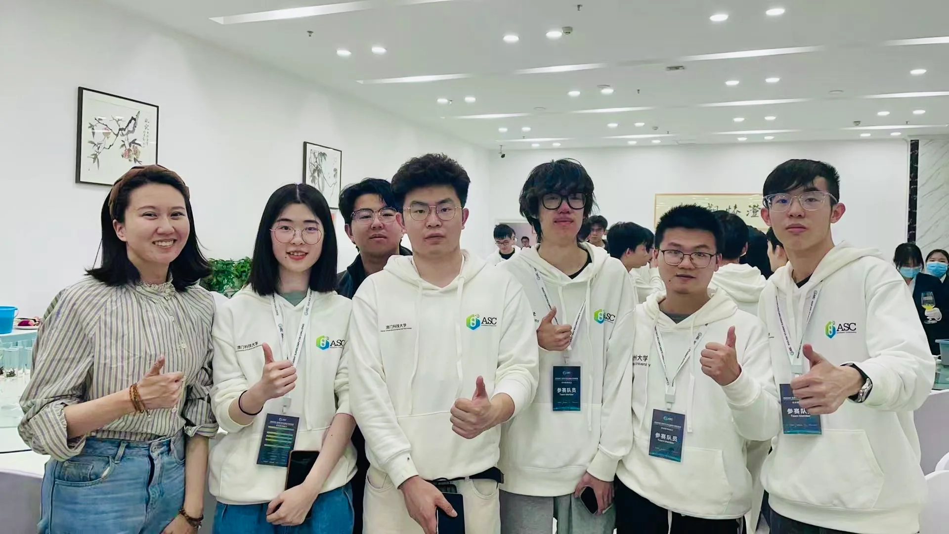 At the dinner, our team and students from other teams giving a thumbs-up together
